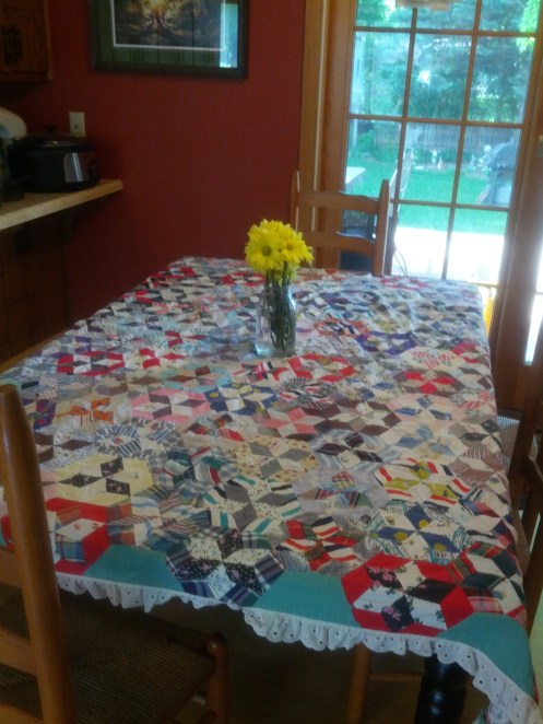 This tablecloth quilt was hand stitched by my Nanny.